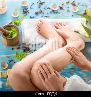 Taking care oiling legs in spa salon. Woman taking spa procedures Stock Photo