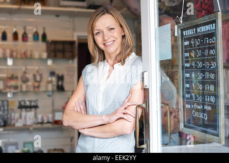 Owner Of Gift Shop Standing In Doorway Stock Photo