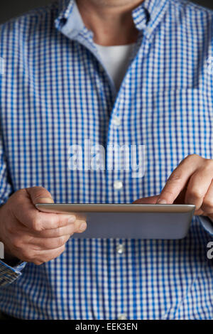 Studio Shot Of Man Using Digital Tablet Stock Photo