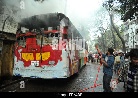 Dhaka, Bangladesh. 19th Jan, 2015. Bangladeshi firefighters extinguish a smoldering vehicles set on fire by opposition demonstrators during violent protests in Dhaka on the 14th day of the countrywide non-stop blockade program enforced by the Bangladesh Nationalist Party-led 20-party alliance on January 19, 2015. Credit:  Mamunur Rashid/Alamy Live News Stock Photo