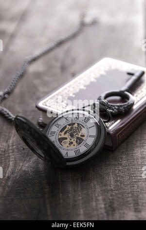 pocket watch on grunge wooden table, close up Stock Photo