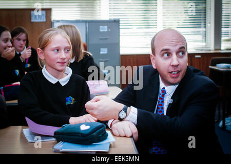 Teacher helping a student with work in a language class, secondary school,UK Stock Photo