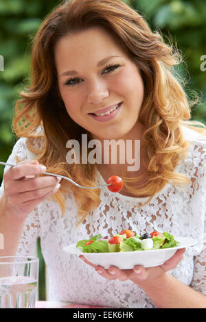 Teenage Girl Eating Healthy Bowl Of Salad Stock Photo