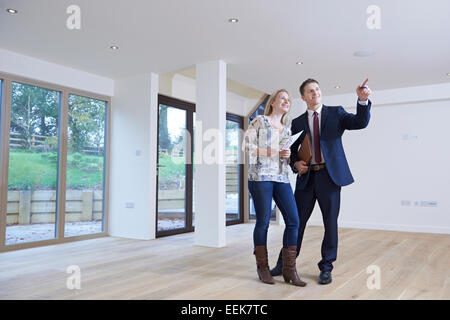 Estate Agent Showing Prospective Female Buyer Around Property Stock Photo