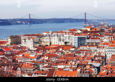 View over city of Lisbon in Portugal with Tejo River and  25 de Abril Bridge in the background. Stock Photo