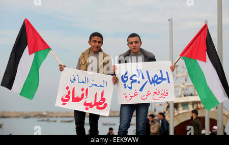 Jan. 19, 2015 - Gaza City, Gaza Strip, Palestinian Territory - Palestinian youth hold placards during a protest demanding for open a waterway between the besieged Gaza Strip and the world, at the Gaza's seaport, January 19, 2015. The governmental Committee to Break the Siege on Gaza declared Monday the beginning of  the rehabilitation of a waterway that would link the Strip with the outside world as a prelude for  the establishment of an international port  (Credit Image: © Ashraf Amra/APA Images/ZUMA Wire) Stock Photo