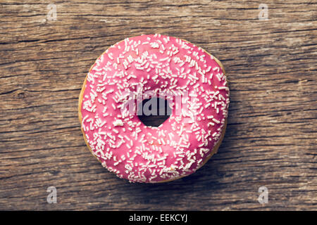 pink donut on old wooden background Stock Photo