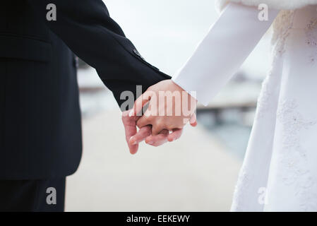 Bride and groom holding hands Stock Photo