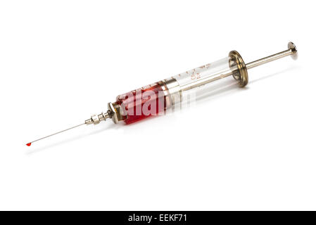 Old medical syringe made of glass and metal with blood Stock Photo