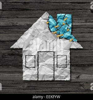 Home repair concept and house improvement symbol as crumpled paper shaped as a residential structure with torn pieces as an icon for renovations and maintenance. Stock Photo