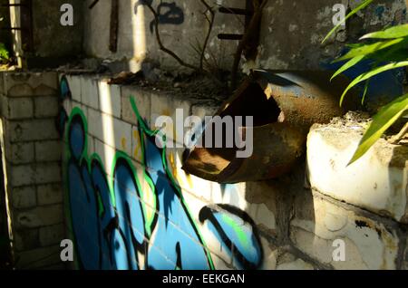 Broken water pipe on the wall inside the derelict pump house building at Govan Graving Docks in Glasgow, Scotland Stock Photo