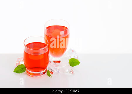 Two glasses of red fruit flavored drinks Stock Photo