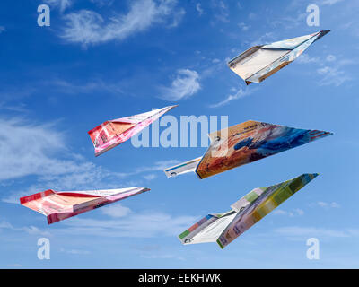 Swiss Franc banknotes as toy planes rising high in the sky Stock Photo