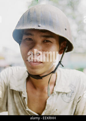 Young vietnamese man wearing army helmet Stock Photo