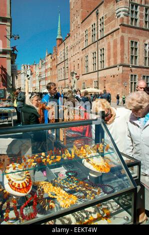 Gdansk Poland. Traditional Baltic coast amber on sale in the Old Town main street of Dlugi Targ with the Main Town Hall behind Stock Photo