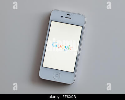 A view of the homescreen of the Google Search app on a white Apple iPhone 4. Stock Photo