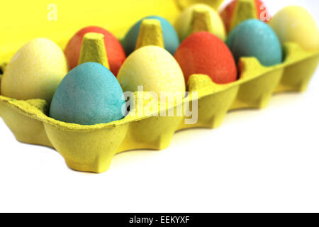 Colorful easter eggs in yellow box on white background Stock Photo