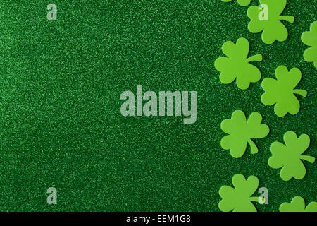 Green Clovers or Shamrocks  on Green Background for St. Patrick's Day Holiday Stock Photo