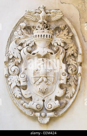 Emblem with royal symbols in bas-relief on a wall Stock Photo