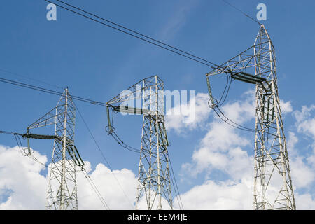 Three metallic towers for high-voltage  electrical energy transmission Stock Photo