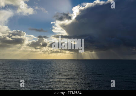 Sunrays shining through clouds over the sea, bad weather front moving in, North Sea, Heligoland, Schleswig-Holstein, Germany Stock Photo