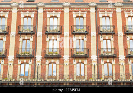 Apartment building facade with rows of balconies in European style