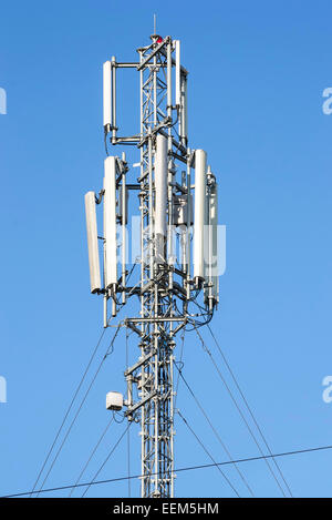 Mobile phone network antennas with various electronic equipments installed on a metallic pole Stock Photo