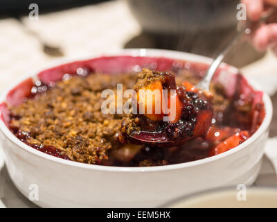 Home-made apple and blackberry crumble. Stock Photo