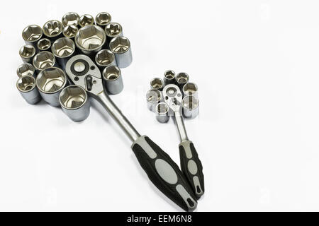 Two socket wrenches with hexagonal bits arranged around them as to resemble the petals of a flower, isolated on white Stock Photo