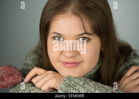 young woman with red valentines heart wearing pullover Stock Photo