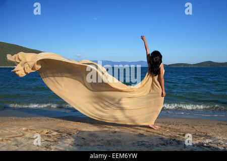 Young woman standing near sea Stock Photo