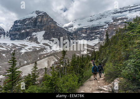 Canada, Banff National Park, Canadian Rockies, Plain of Six Glaciers, Rear view of hikers walking along trail Stock Photo