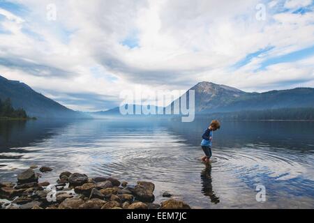 Boy wading in a lake, USA Stock Photo