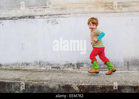 Portrait of a cool boy running along the street, USA Stock Photo