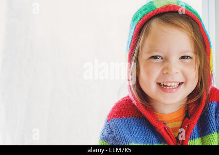 Portrait of  a smiling girl wearing a striped hoodie Stock Photo