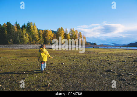 Rear view of a girl walking in rural landscape, USA Stock Photo