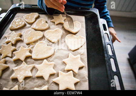 Mari boy baking cookies in kitchen Stock Photo