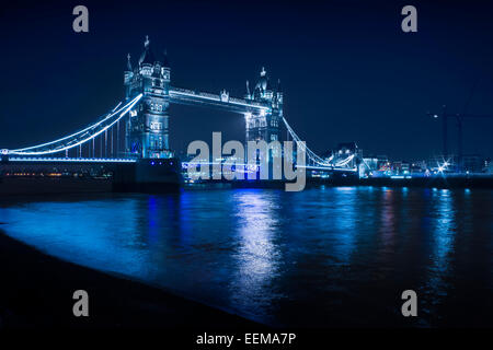 Illuminated iconic bridge in cityscape at night, London, England, United Kingdom Stock Photo