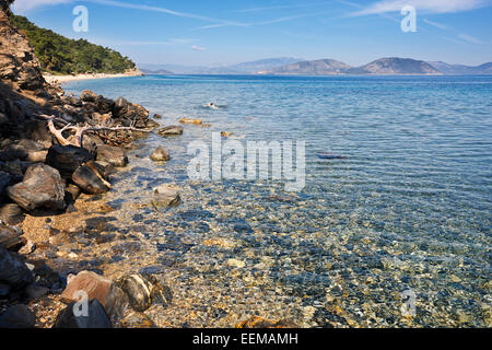 Rocky beach with crystal clear water in Dilek Peninsula National Park, Aydin Province, Turkey. Stock Photo