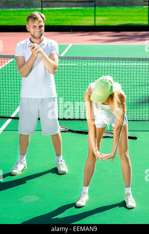 Young couple training on the tennis court Stock Photo