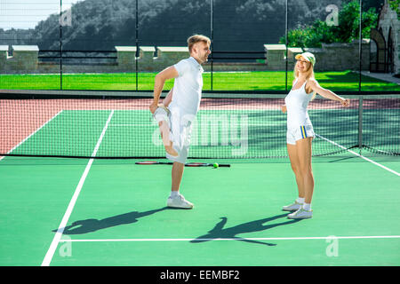 Young couple training on the tennis court Stock Photo