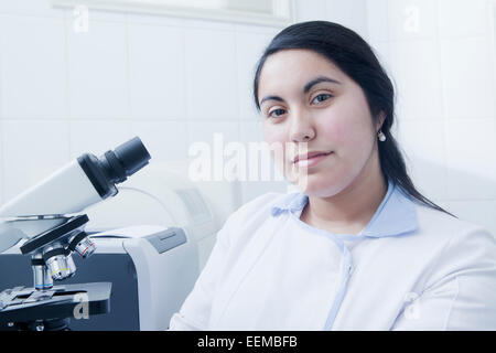 Hispanic scientist smiling in laboratory Stock Photo