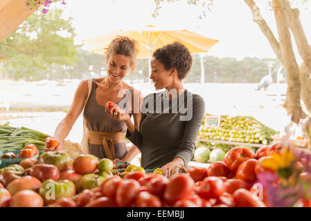 Women browsing produce at farmers market Stock Photo