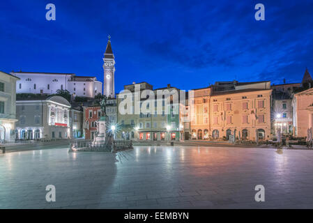 Town square, tower and buildings illuminated at night, Piran, Coastal-Karst, Slovenia Stock Photo