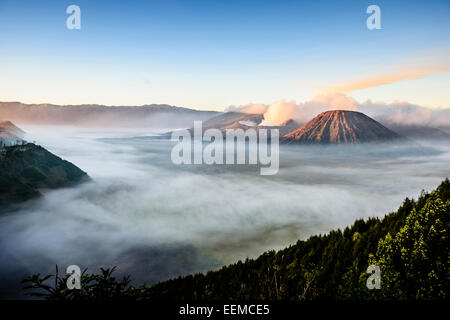 High angle view of clouds under smoking volcano Stock Photo