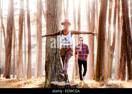 Couple exploring sunny forest