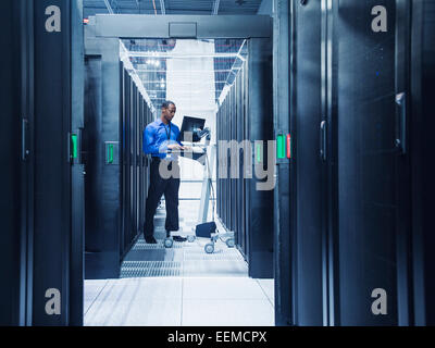 Black businessman using computer in server room Stock Photo