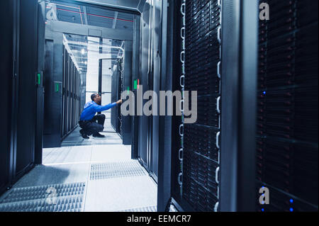 Black businessman working in server room Stock Photo