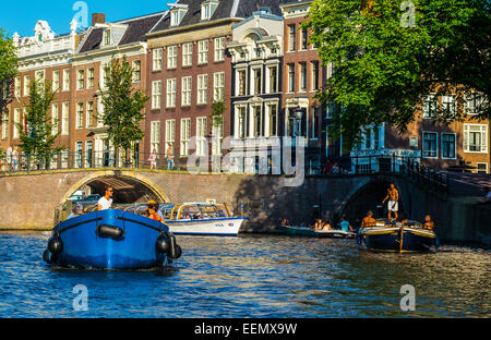 Amsterdam, tourists enjoiing a boat trip in the canals of the old city center Stock Photo