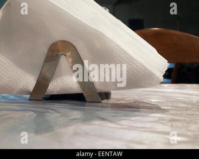 Paper napkins in holder at restaurant Stock Photo